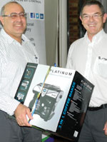 Johan Maartens (right) handing over the coffee machine won by DR Shorer at the SAIMC rebranding lucky draw.